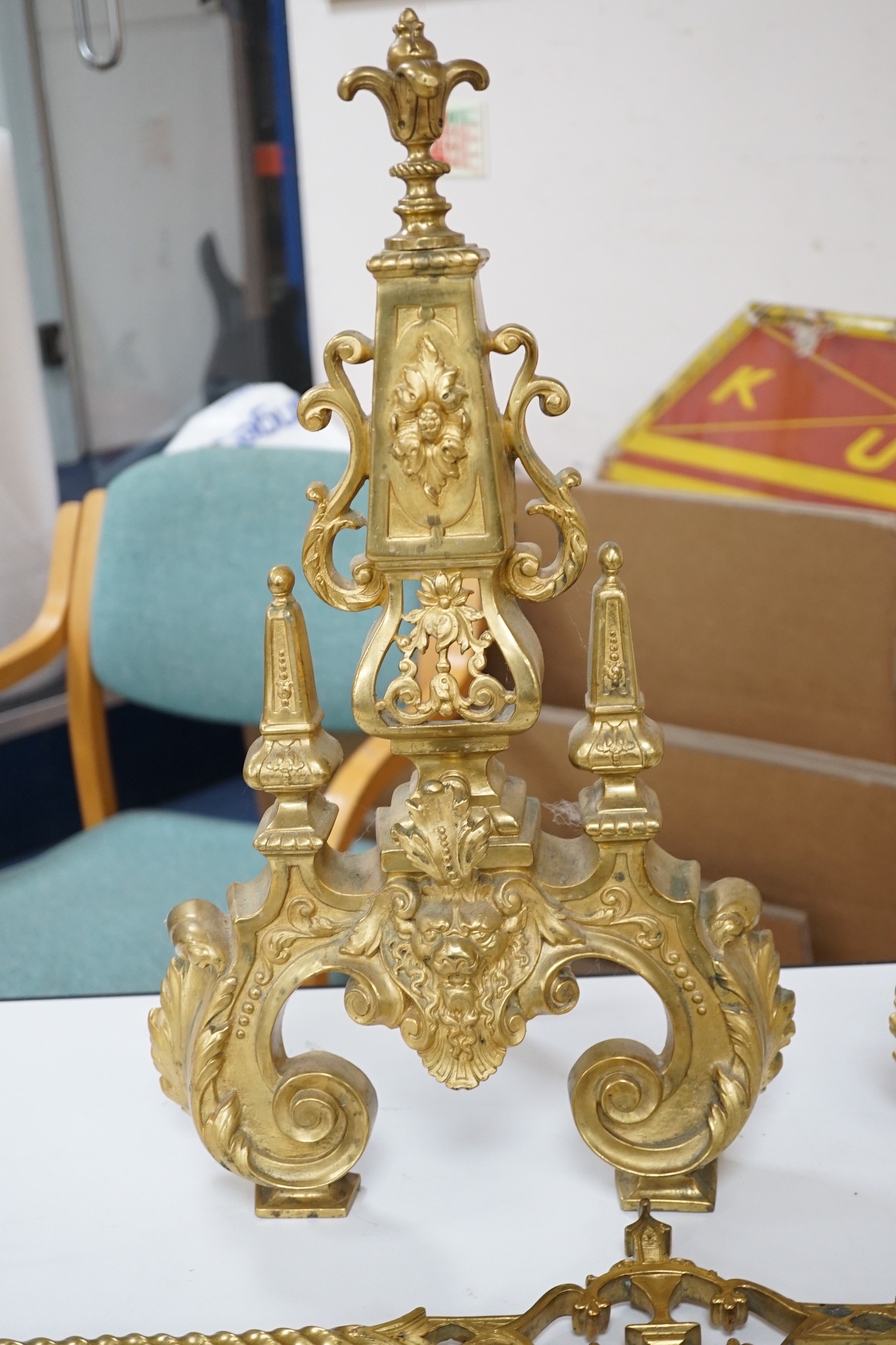 A pair of cast brass fire dogs with adjustable bar, 52cms high
